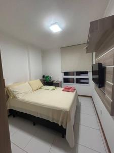 מיטה או מיטות בחדר ב-Apartamento ITAIGARA