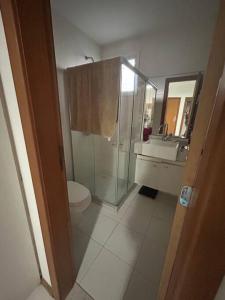 a bathroom with a shower and a toilet and a sink at Apartamento ITAIGARA in Salvador