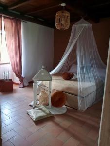 a bedroom with a bed with a mosquito net at La soffitta di Megan in Cesano