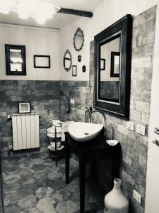 a black and white bathroom with a sink and a toilet at Via Castello 17 in Bienno
