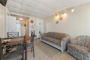 a living room with a couch and a table at 404 E Denver Ave, Unit 403 in Wildwood Crest