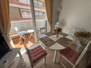 a table and chairs in a room with a balcony at Ferienwohnung Torrevieja España in Torrevieja +7 photos
