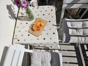 a plate of orange slices on a polka dot chair at Apartman Sara-Vis in Vis