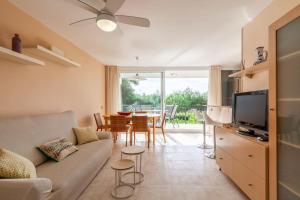 a living room with a couch and a table at 50 meters from CALA CRANCS- Terrace and seaviews in Salou