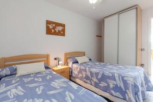two beds sitting next to each other in a bedroom at 50 meters from CALA CRANCS- Terrace and seaviews in Salou