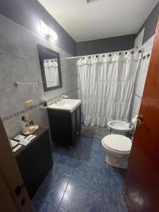 a bathroom with a toilet and a sink at Departamentos PRANA C con COCHERA in Villa Mercedes