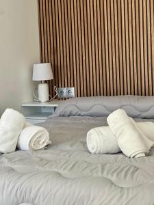 a white bed with towels on top of it at Verdial 1 Atico in Cala del Moral