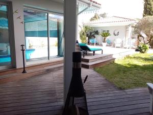 a bottle of wine sitting on the porch of a house at Aresia in Arès