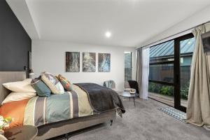 a bedroom with a bed and a large window at The Front Room in Wanaka