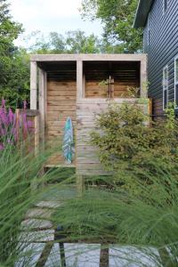 a wooden shed with a bench in a garden at Woodland Chase - Pool & Hot Tub by Wineries ST 2020-0259 in Wellington