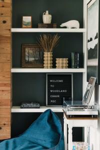 a room with a desk with a laptop on a shelf at Woodland Chase - Pool & Hot Tub by Wineries ST 2020-0259 in Wellington