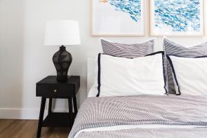 a bedroom with a bed and a lamp on a nightstand at Woodland Chase - Pool & Hot Tub by Wineries ST 2020-0259 in Wellington