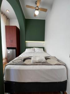 a bedroom with a bed with a ceiling fan at Gamora Hotel Playa in Los Órganos