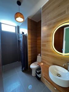 a bathroom with a sink and a toilet and a mirror at Gamora Hotel Playa in Los Órganos