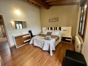 1 dormitorio con 1 cama y suelo de madera en A MIÑA CASIÑA -TERMAS OURENSE, en Ourense