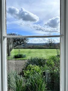 an open window with a view of a field at Unique apartment in stunning Manor house in Potterne