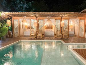 una piscina con sedie e una tenda di Habitación luxury Loto Mendihuaca tayrona a Santa Marta