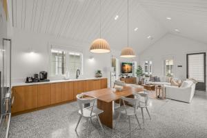 a kitchen and living room with a wooden table and chairs at NEW! The Humidor - 2 Epic, Luxury Ybor Townhomes, Steps to 7th Ave in Tampa