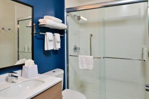 a bathroom with a shower and a toilet and a sink at Spark By Hilton Dallas Market Center in Dallas