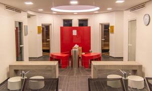 a waiting room with red chairs and a red wall at Wellnesshotel Hohenrodt in Loßburg