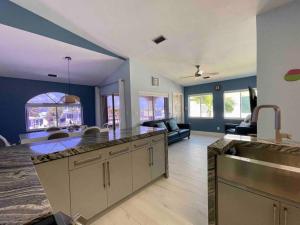 a kitchen and living room with a counter top at Easy Ocean Access 30' Dock - House - Private Club w/ Heated Pool and Sandy Beach in Key Colony Beach