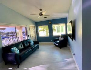 a living room with a couch and two chairs at Easy Ocean Access 30' Dock - House - Private Club w/ Heated Pool and Sandy Beach in Key Colony Beach