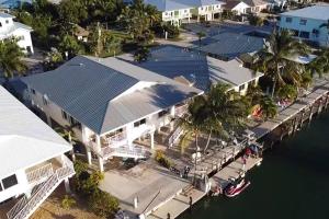 an aerial view of a house on the water at Easy Ocean Access 30' Dock - House - Private Club w/ Heated Pool and Sandy Beach in Key Colony Beach