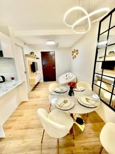 a living room with a table and chairs and a kitchen at Eurto Stay in Mandaue City