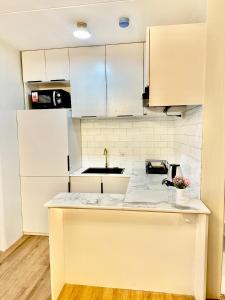 a kitchen with white cabinets and a counter top at Eurto Stay in Mandaue City