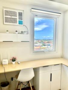 a desk with a window and a white chair at Eurto Stay in Mandaue City
