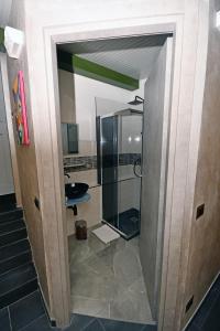 a bathroom with a shower and a glass door at Camera di Molly in Leivi