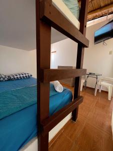 a bedroom with a bunk bed and a bunk room with a bunk bed gmaxwell gmaxwell at Gamora Hotel Playa in Los Órganos