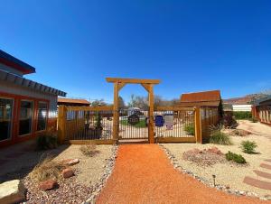 a wooden fence in front of a house at Timber & Tin G 2Bed 2Bath w Pool & Rooftop Deck in Kanab