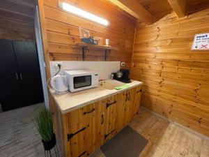 a small kitchen with a microwave on a counter at Pnina BaMarom in Sifsufa