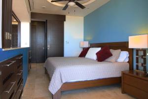 a bedroom with a bed and a ceiling fan at Pinnacle Resort-Style Condo - Luxurious Balcony in Puerto Vallarta +18 photos