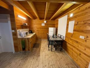 a kitchen with a counter and a table with a microwave at Pnina BaMarom in Sifsufa