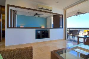 a living room with a fireplace and a glass table at Pinnacle Resort-Style Condo - Luxurious Balcony in Puerto Vallarta