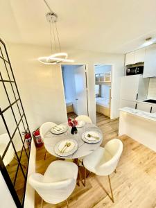a dining room with a table and white chairs at Eurto Stay in Mandaue City