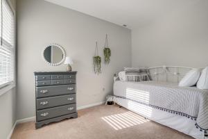 a bedroom with a bed with a mirror and a dresser at Benton Harbor Home with Fire Pit - 2 Mi to Beach! in Benton Harbor