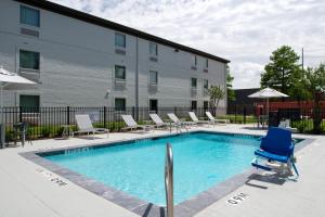 a swimming pool with lounge chairs and a building at Spark By Hilton Dallas Market Center in Dallas
