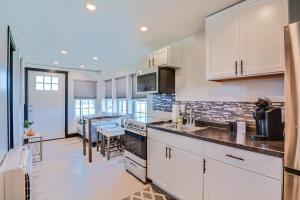 a kitchen with white cabinets and a counter top at One-of-a-Kind Container Home on Century Farm! in Mount Vernon