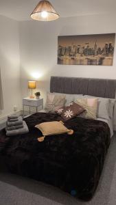 a bedroom with a large bed with pillows on it at City Centre Flat with Free Parking in Newport