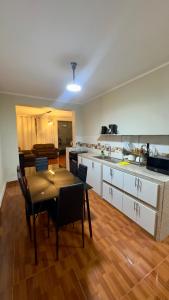 a kitchen and dining room with a table and chairs at CASTELLARES LA PUEBLA APARTAMENT in Ayacucho