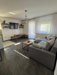 a living room with a couch and a table at Bellas apartmani in Novi Sad