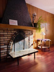 a brick fireplace with a bench in front of it at Hosteria El Ñire in San Carlos de Bariloche