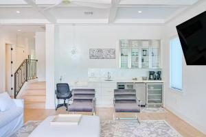 a white living room with a couch and a kitchen at Tropical Gulf View Estate - Anna Maria, FL in Anna Maria