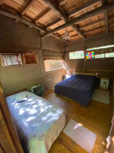 a room with a bed and a bed in a house at Eco habitación en Tierra Fértil Eco Posada in Santa Ana