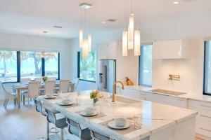 a kitchen with a large island in the middle at Tropical Gulf View Estate - Anna Maria, FL in Anna Maria
