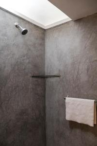 a bathroom with a shower with a towel at New Family Home with Pool Jacuzzi & Fronton in Cuernavaca +37 photos