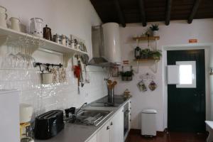 a kitchen with a sink and a counter top at C M Casa de Mares Alojamento Local in Casas Novas de Marés +18 photos
